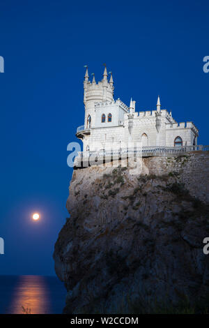 Ukraine, Crimea, Yalta, Gaspra, Full moon over  shines over The Swallow's Nest castle perched on Aurora Clff Stock Photo