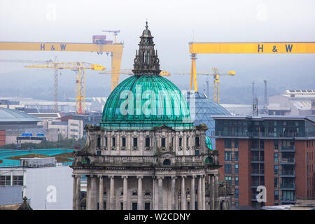 United Kingdom, Northern Ireland, Belfast, City Hall with Harland and Wolff cranes know as Samson and Goliath in distance Stock Photo