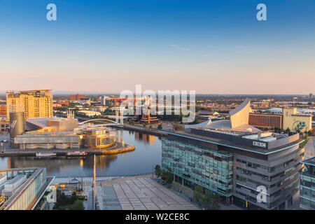 UK, England, Manchester, Salford, View of Salford Quays looking towards the Lowry Theatre, Millennium Bridge also known as The Lowry Bridge, Old Trafford, BBC studios and Imperial War Museum North