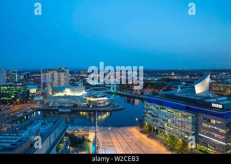 United Kingdom, England, Greater Manchester, Manchester, Salford, View of Salford Quays looking towards the Lowry Theatre, Millennium Bridge also known as The Lowry Bridge, Old Trafford, BBC studios and Imperial War Museum North Stock Photo