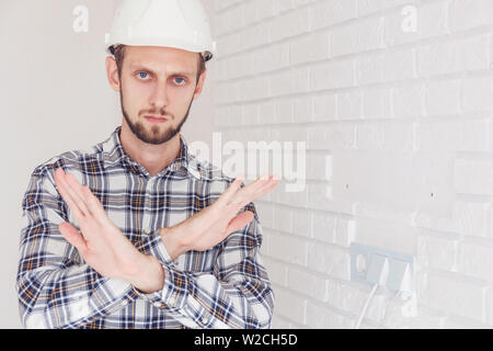 Foreman engineer, arms folded, shows a ban on action. Stock Photo