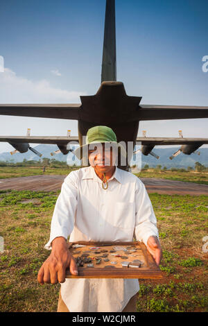 Vietnam, DMZ Area, Quang Tri Province, Khe Sanh, Former Khe Sanh US Combat Base, museum, former US Air Force, C-130 Hercules, transport plane and man selling war souvenirs Stock Photo