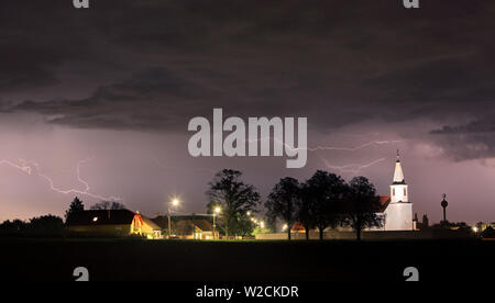 Lightning bolts over church Stock Photo