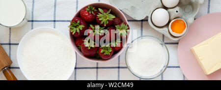 Strawberry pie ingredients (flour, eggs, butter, milk, sugar, strawberry). Cooking strawberry pie or cake. Stock Photo