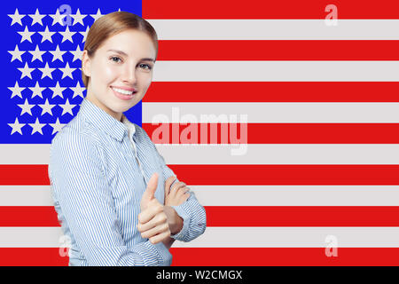 Portrait of happy american girl with thumb up against the USA flag background. Travel and learn english language concept Stock Photo