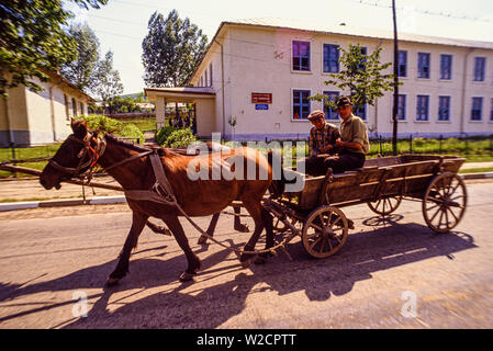 Romania. May 1990. Rural scene. Two men ride a cart pulled by two horses. Photo: © Simon Grosset. Archive: Image digitised from an original transparency. Stock Photo
