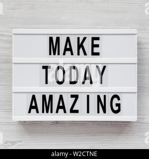 'Make today amazing' words on a modern board on a white wooden surface. From above, overhead, flat lay, top view. Closeup. Stock Photo