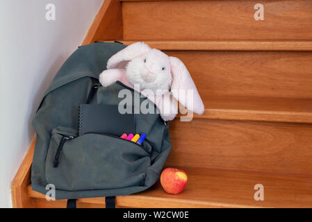 School bag with cuddly toy, supplies and lunch Stock Photo