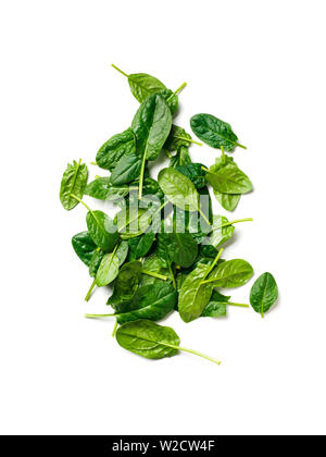 Heap of baby spinach leaves. Fresh green baby spinach isolated on white with clipping path. Top view or flat lay. Vertical. Stock Photo