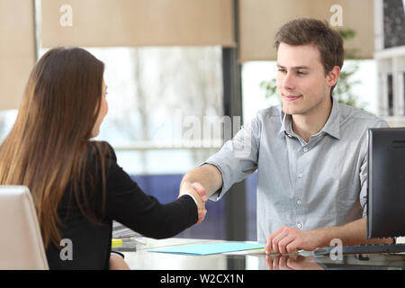 Serious businesspeople handshaking after deal at office Stock Photo