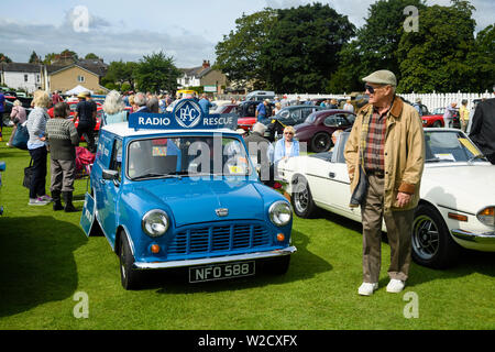 1961 commercial motorcar (Austin Mini Van RAC Radio Rescue) on display & people visiting Classic Vehicle Show - Burley-In-Wharfedale, England, UK. Stock Photo