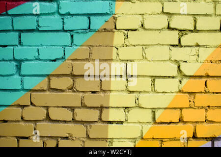 Multi-colored brick surface, painted in different colors. Creative background texture. Stock Photo