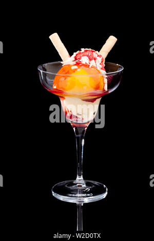 ice cream sundae: A cup of peach ice cream isolated on black background Stock Photo