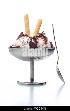 ice cream sundae: a stracciatella ice cream sundae in classical metal pot with spoon on white background Stock Photo