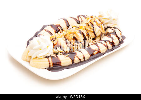 ice cream sundae: Banana split ice cream sundae on plate with almonds, whipped cream and chocolate topping on white background Stock Photo