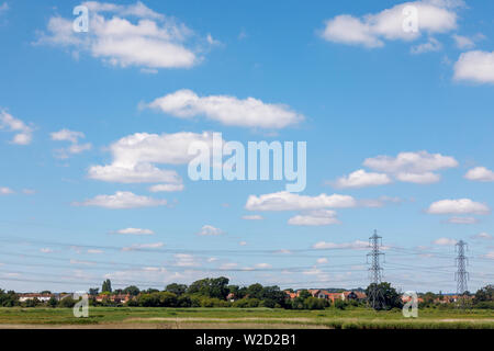 View over reed beds of the River Test estuary at Redbridge as it enters Southampton Water looking towards Totton with electricity pylons and lines Stock Photo