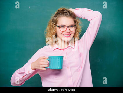 Great time. energy and vigor. energy charge. school teacher need coffee break. good morning. girl refreshing with tea drink. idea and inspiration. woman with coffee cup at blackboard. Stock Photo