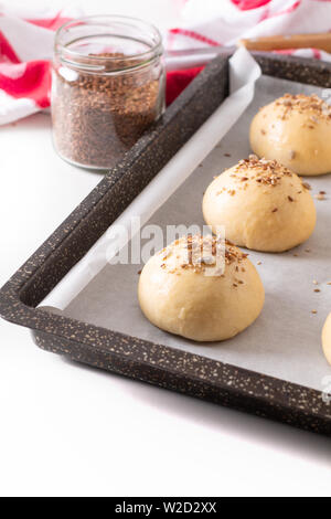 Food concept Proving, Proofing yeast dough of hamburger buns in bake pan before baking Stock Photo