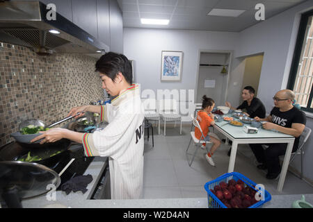 (190708) -- LINHAI, July 8, 2019 (Xinhua) -- Wu Yuanmiao and his host family have dinner in Lucheng community of Linhai City, east China's Zhejiang Province, June 26, 2019. Wu Yuanmiao, when working as a barber, set a rule for himself to provide free service one day a week to the old, the disabled, and soldiers. Having served more than 60,000 customers for 17 year, he is the winner of various awards including May 1 Labor Medal. However, diagnosed with brain disease, Wu's condition has been worse off since 2008. In 2014, he experienced a hard time in running his barber shop and providing pub Stock Photo