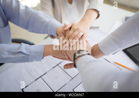 close up of business team stacking hands Stock Photo
