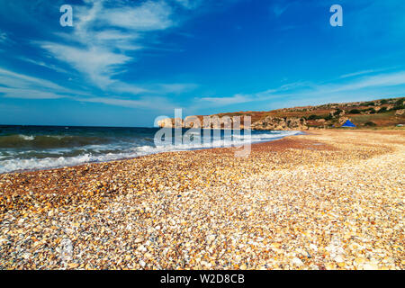 Shell beach. Coast of the Black Sea. Selective focus on foreground. Stock Photo