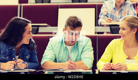 group of students with notebooks in lecture hall Stock Photo