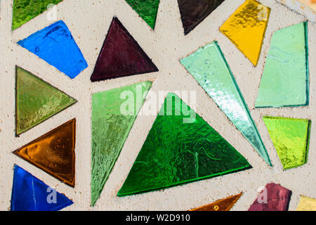Mosaic surface made of multi-colored glass. Abstract mosaic glass tiles patterned background. CLose up. Stock Photo