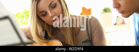 Music Playing Lesson Lovers Couple at Living Room Stock Photo