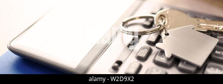 Calculator on Notepad, Key with Trinkel Desktop Stock Photo