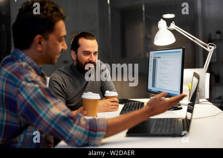 creative team drinking coffee at night office Stock Photo