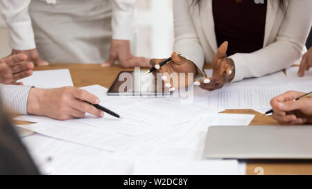 Business people group work with papers on table, close up Stock Photo