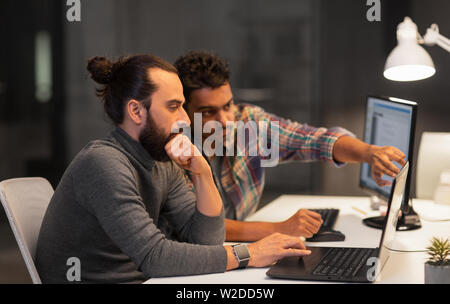 creative team with computer working late at office Stock Photo