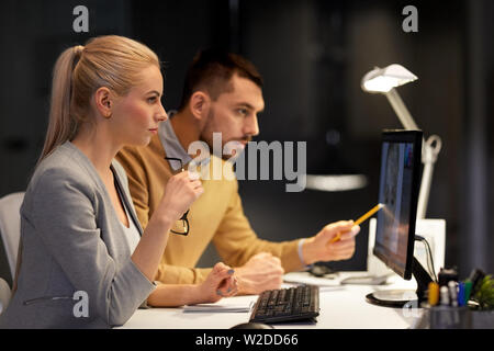 designers with computer working at night office Stock Photo