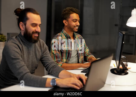 creative team with computer working late at office Stock Photo