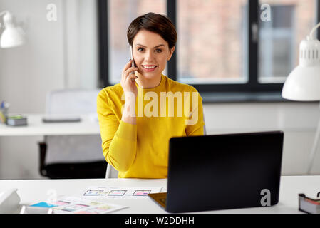 ui designer calling on smartphone at office Stock Photo