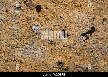 Close up of the mottled surface pattern and texture of handmade bricks. Stock Photo