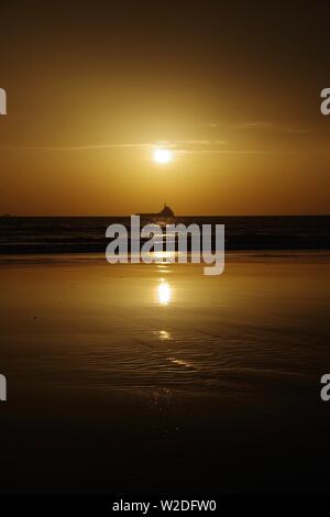 Silhouetted Oil Support Vessel on the North Sea Offshore Aberdeen at Sunrise. Scotland, UK. Stock Photo
