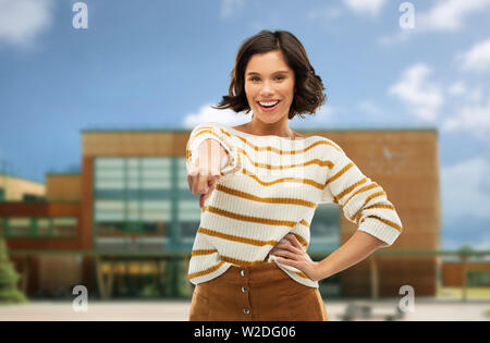 young woman pointing finger to you over school Stock Photo