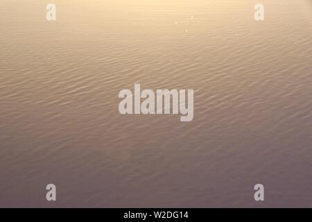 Capillary Waves / Ripples Flowing Over Wet Beach Sand. Natural Abstract ...