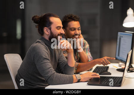 creative team with computer working late at office Stock Photo
