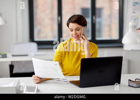 ui designer calling on smartphone at office Stock Photo