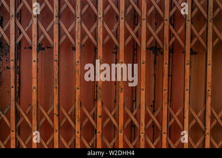 Ancient iron orange doors are very rusty for background, Steel folding gates, thailand, Vector illustration. Stock Photo