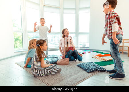 Nice cute boy standing in front of his friends Stock Photo