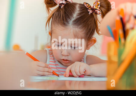 Nice cute girl holding a felt pen Stock Photo