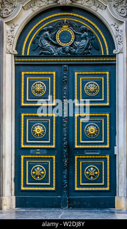 Old classic doorway decorated with gold and patterns, angel statues above the door, historical architecture Stock Photo