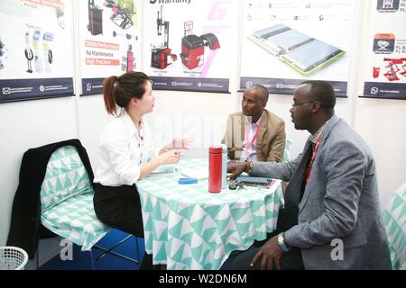 (190708) -- BEIJING, July 8, 2019 (Xinhua) -- A trader (L) converses with customers during the 5th Edition of China Trade Week at Kenyatta International Convention Center (KICC) in Nairobi, capital of Kenya, June 7, 2019. China Trade week is a series of successful Business-to-Business (B2B) and Business-to-Government (B2G) trade platforms across the Middle East and Africa covering multiple industries including building and construction materials, lighting, furniture and interior, technology, agriculture, textiles and auto parts. (Xinhua/Charles Onyango) Stock Photo