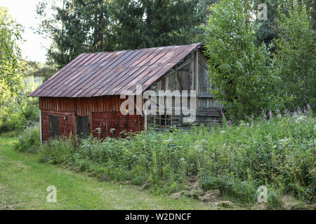 Weathered red ocher barn in Virolahti, Finland Stock Photo