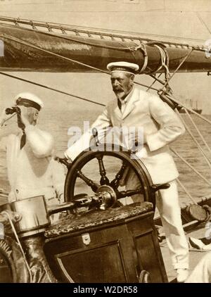 King George V at the wheel of of his yacht, Britannia, during Cowes Regatta week, 1924, (1935).   Creator: Unknown. Stock Photo