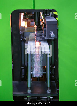 Process of PET plastic bottle on plastic Bottle blowing machine Stock Photo