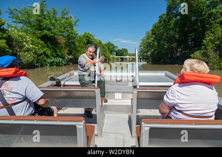 Thibodaux, Louisiana - A park ranger gives a talk to visitors during a boat tour on Bayou Lafourche. Tours are offered by the Wetlands Acadian Cultura Stock Photo